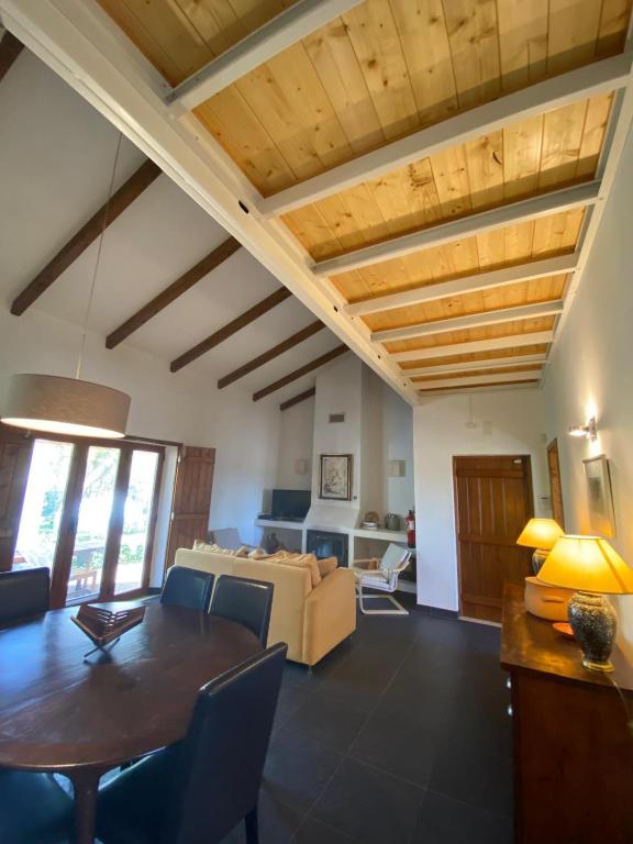 a living room with a table and a couch at Montadinho Houses in São Bartolomeu da Serra