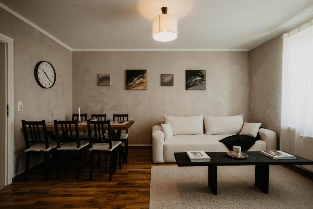 a living room with a couch and a table at Bauhaus Museum Apartment in Dessau