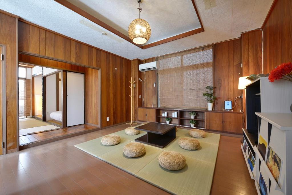 a living room with a table and four spheres on the floor at Mensore Houese in Naha