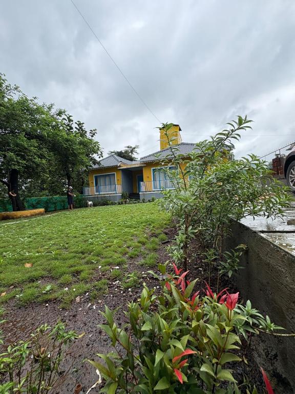 a house with a yard in front of it at Aweka Villa - 3 BHK Riverside - Karjat in Dhamni