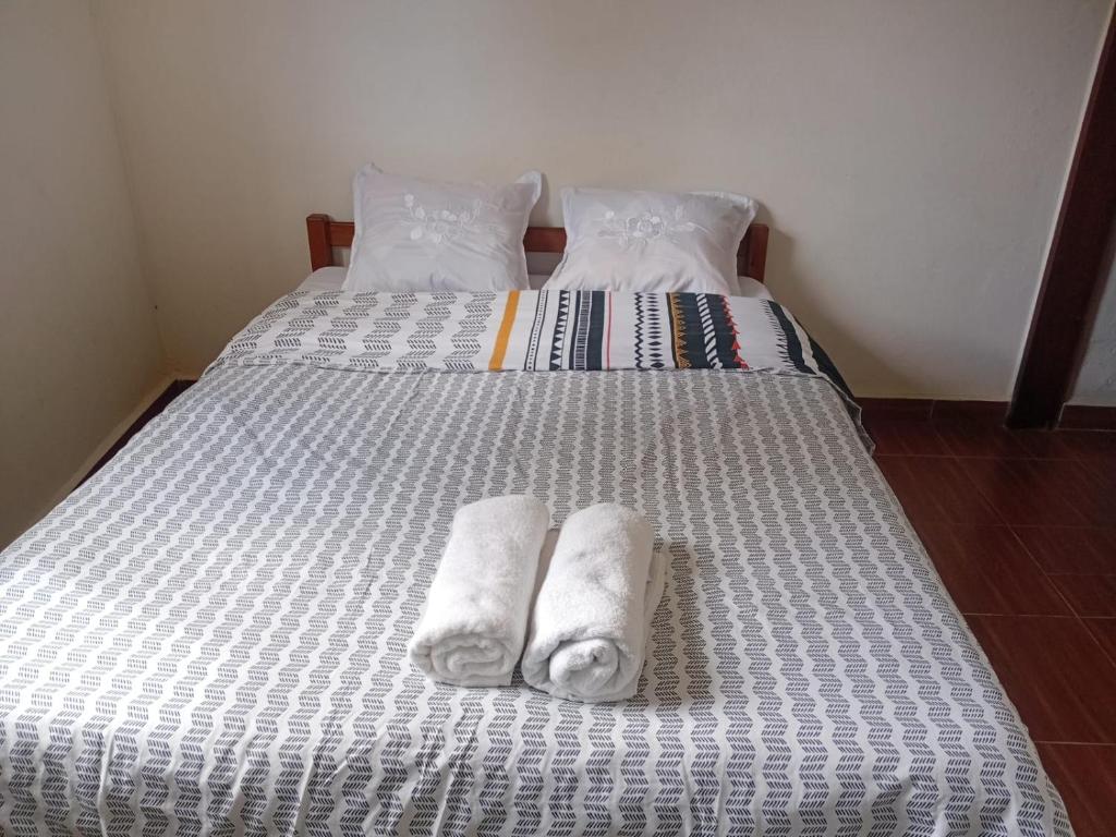 a bed with two towels on top of it at Chez Pauline in Sainte Marie