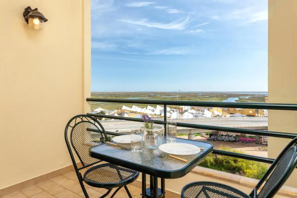 a table and chairs on a balcony with a view at Blife Vitorya private apartment in Faro