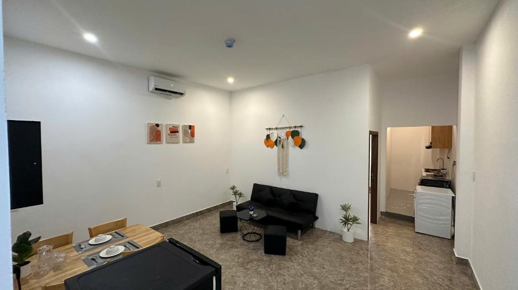 a living room with a couch and a television at D'Igel Boutique in Da Nang