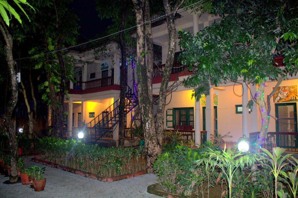 a house with a staircase in front of it at night at Wild Horizons Guest House in Sauraha