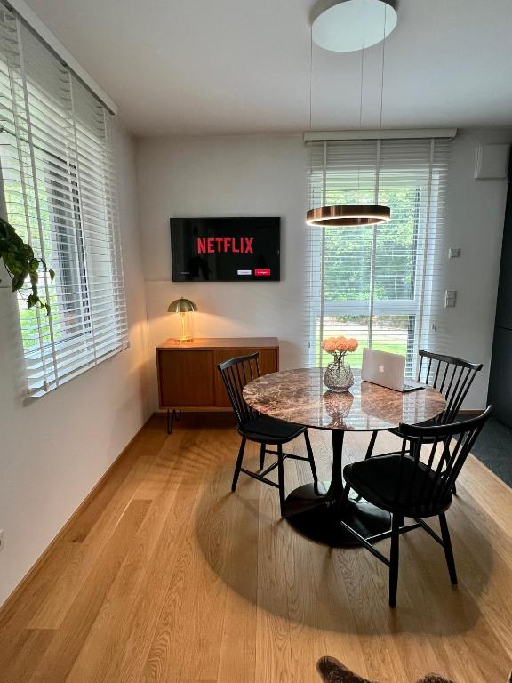 a dining room with a table with chairs and a laptop at Lux city apartment in Luxembourg