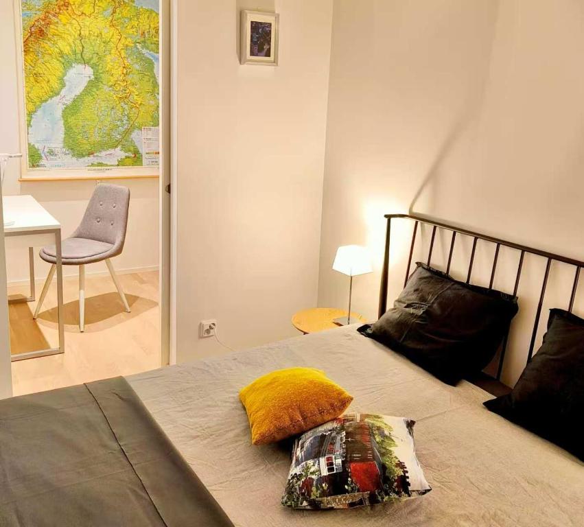a bedroom with a bed with a pillow on it at Long Journey Helsinki in Helsinki