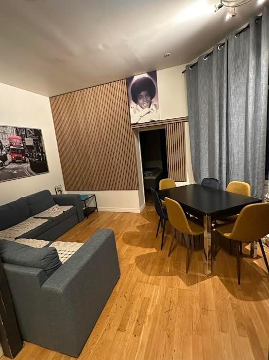 a living room with a couch and a table and chairs at OSLO S, City Center Apartments in Oslo