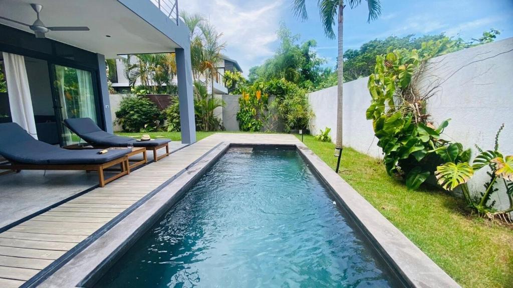 a swimming pool in the backyard of a house at Private Pool Villa With Parking in Las Terrenas