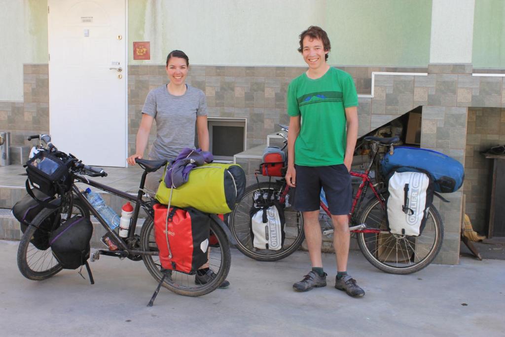 two young men standing next to their bikes at Aleks Guest House in Samokov