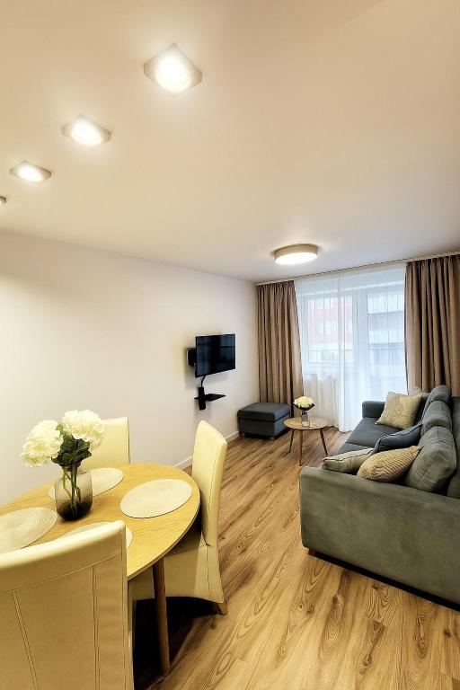 a living room with a couch and a table at TK Apartments Spiżowa in Wrocław