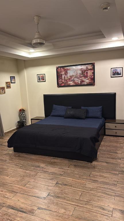 a bedroom with a large bed in a room at Modern 1BR Apartment Bahria Heights 1 in Rawalpindi