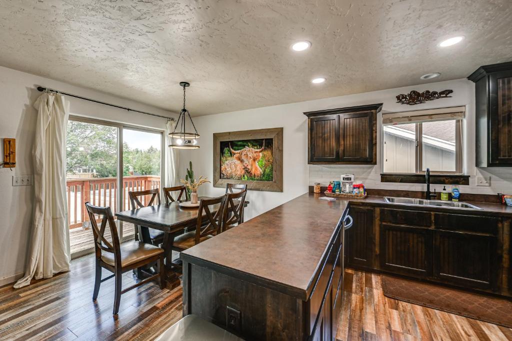 a kitchen and dining room with a table and chairs at Walk to Downtown Family-Friendly Cody Home! in Cody