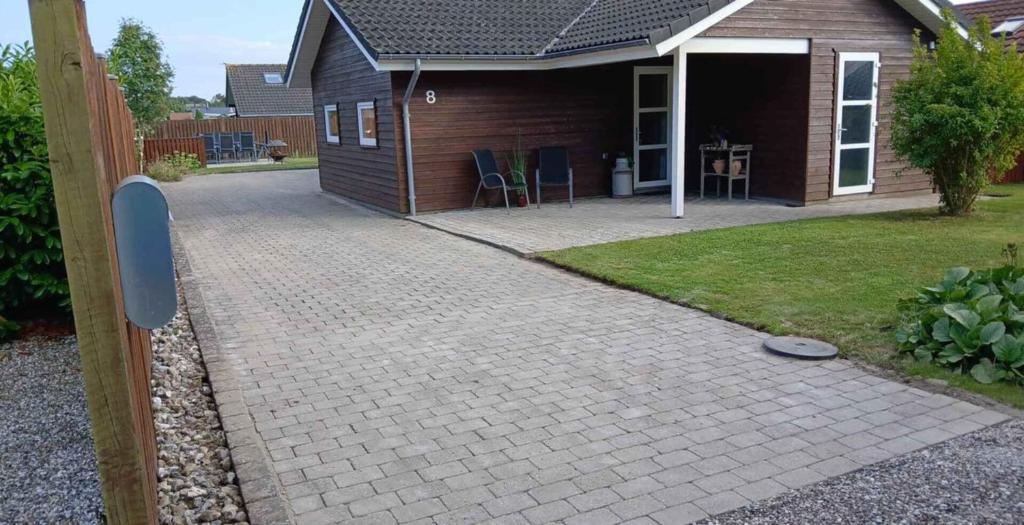 a brick driveway in front of a house at Cosy Cottage On North Funen Near Beach in Otterup