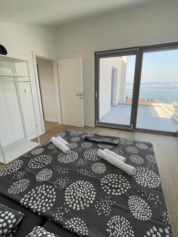 a bedroom with a black and white bed and a window at Villa Una in Crikvenica