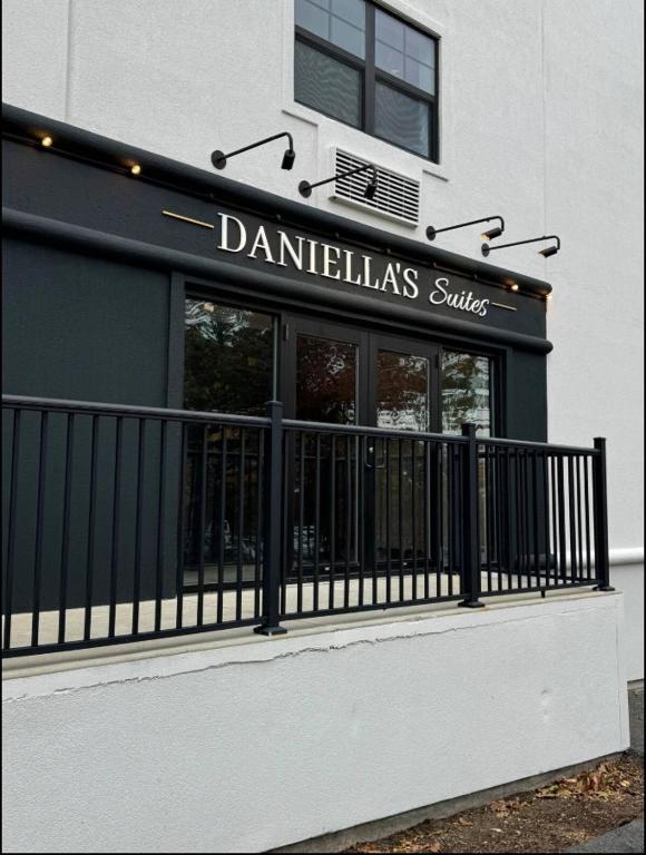 a danteliasulseulse sign on the front of a building at Daniella's Suites in Peabody