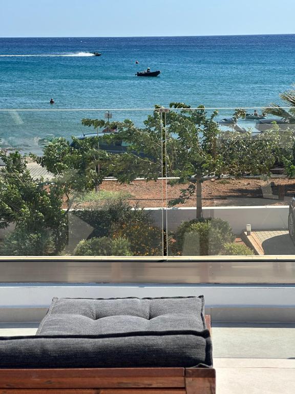 a room with a couch and a view of the ocean at Fantasea Beachfront Villa in Makry Gialos
