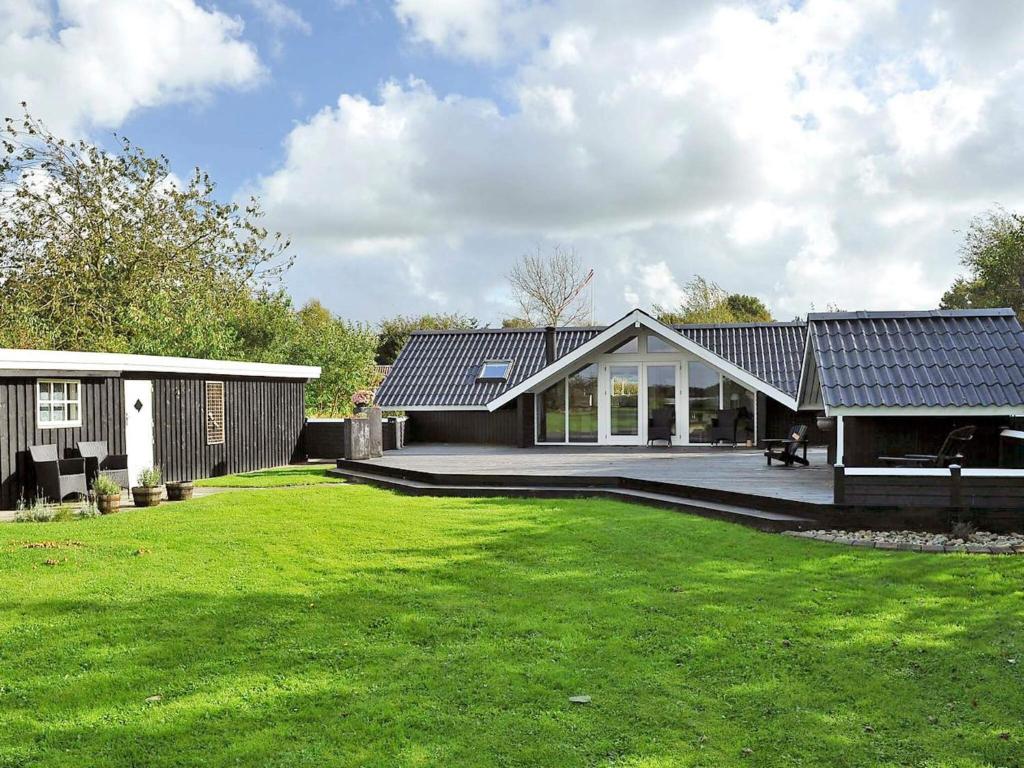 a house with a large lawn in front of it at 6 person holiday home in Ansager-By Traum in Ansager