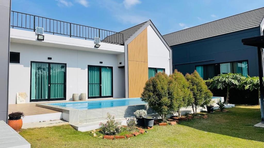 a house with a swimming pool in the yard at Poolla Poolla Villa Khaoyai in Pak Chong