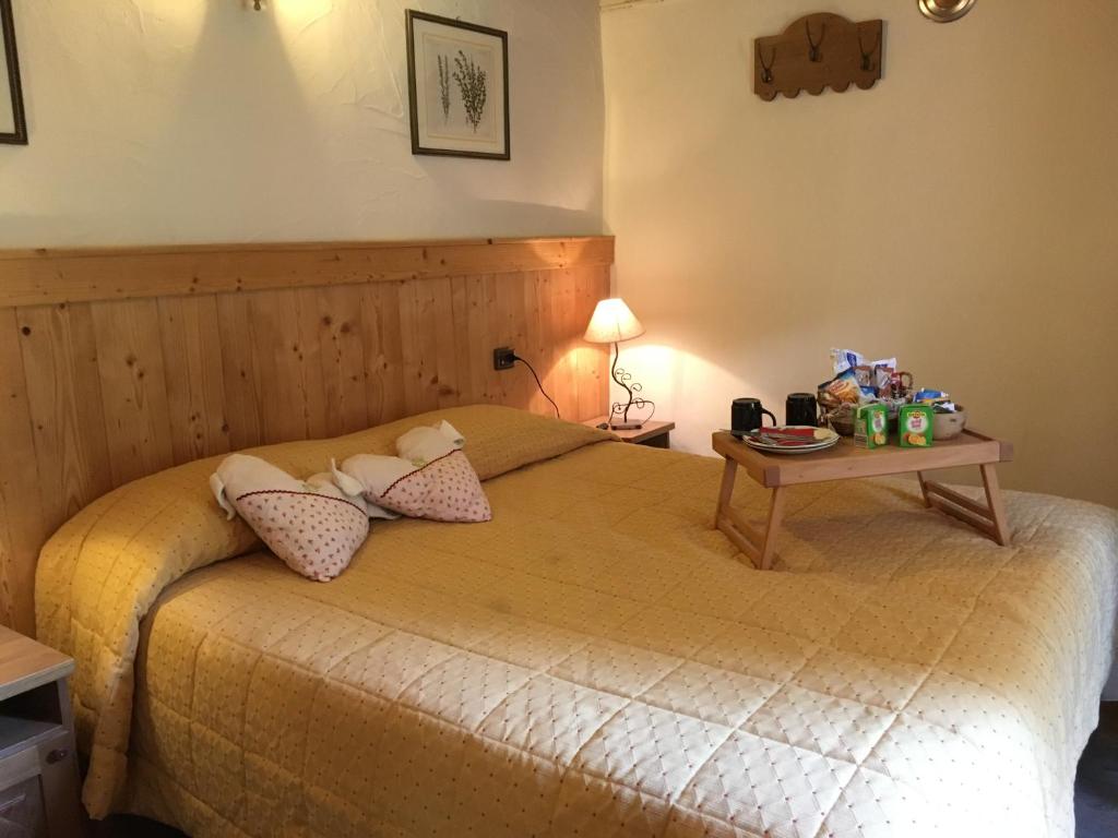 a bedroom with a bed with a table on it at Maison Colombot in Aosta