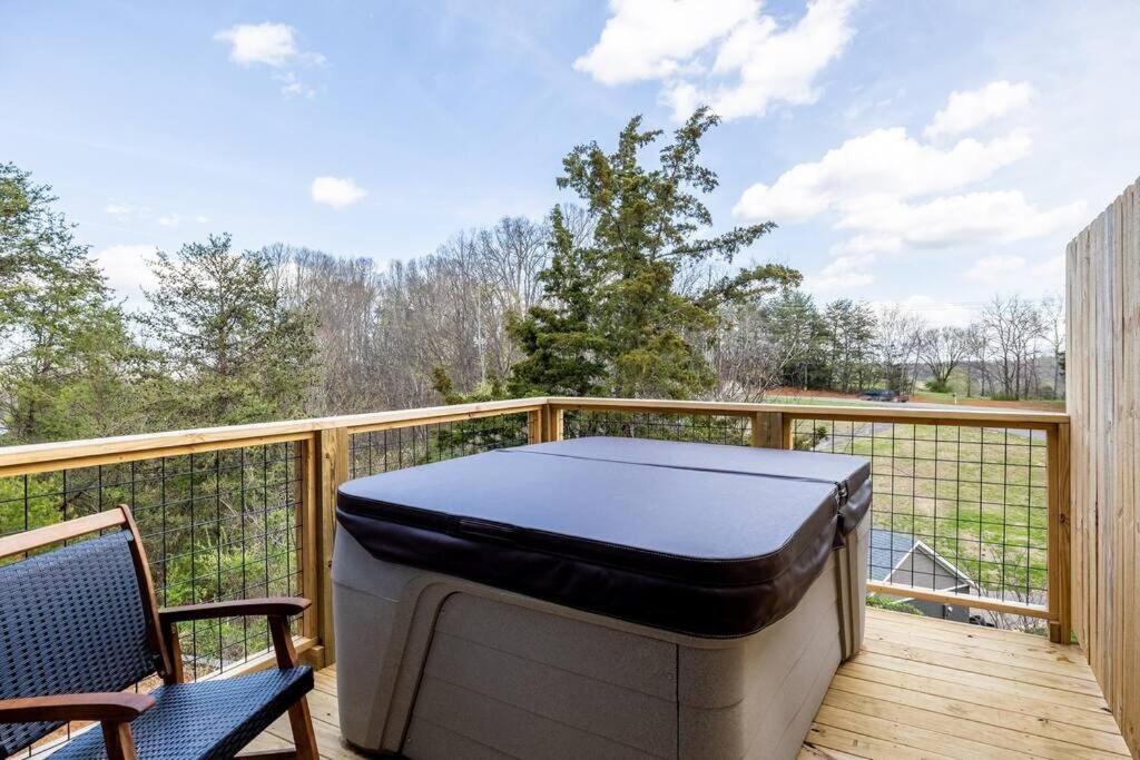 a hot tub sitting on the deck of a balcony at Charming Hideaway near Dolly w Hot tub & Arcade in Sevierville