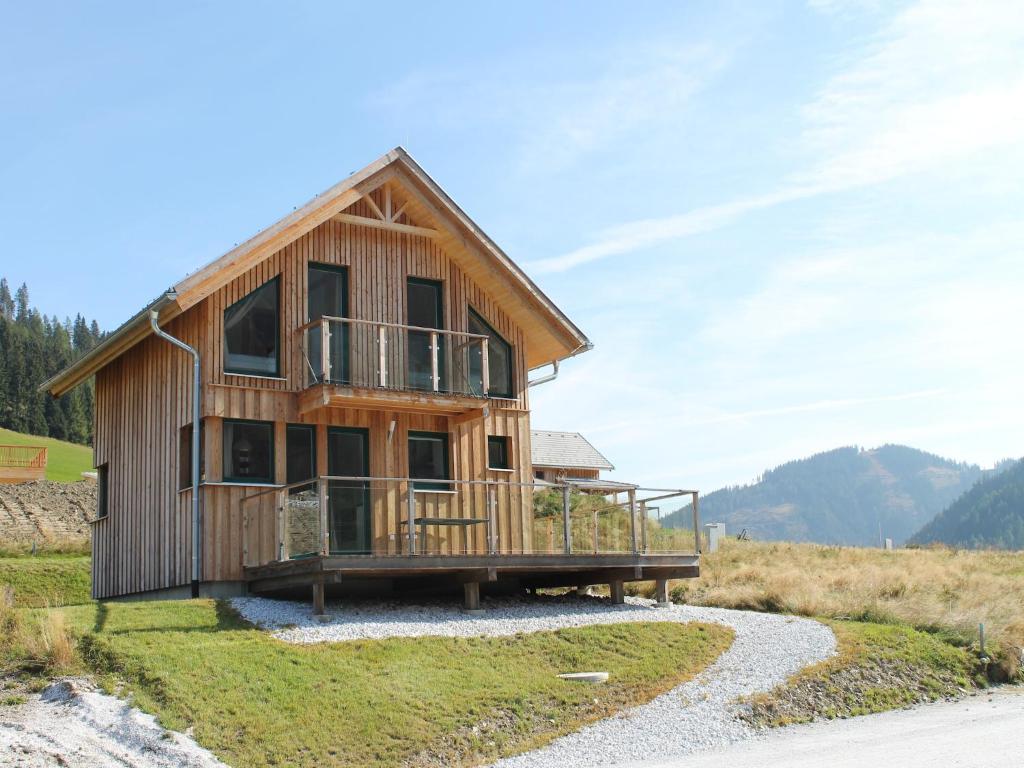 a wooden house on a hill with a path at Chalet in Hohentauern near Ski Lift in Hohentauern
