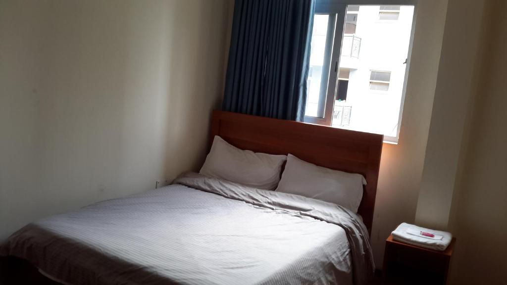 a bed in a small room with a window at Sport Guest House in Addis Ababa