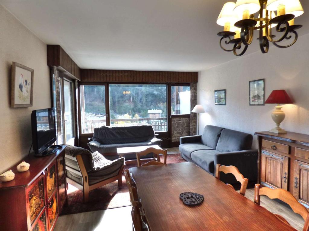 a living room with a couch and a table at Appartement lumineux au ski pour 6 - Grand balcon, cœur du village - FR-1-458-96 in Le Grand-Bornand