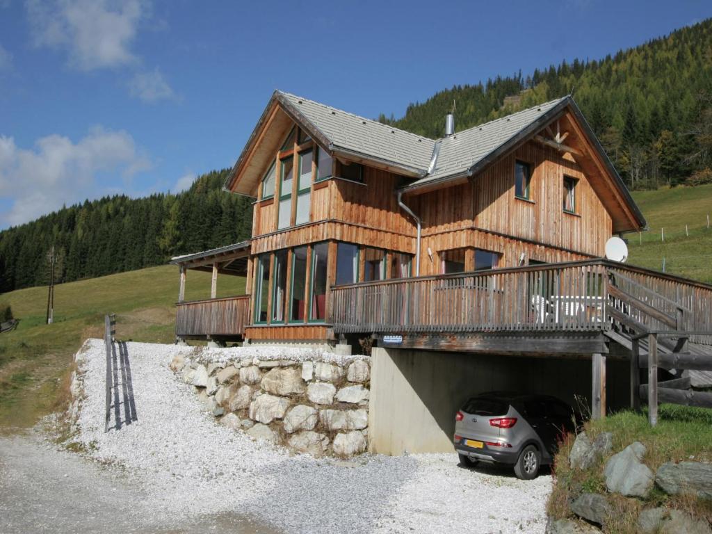 a house with a car parked in a garage at Chalet Hohentauern am Skilift in Hohentauern