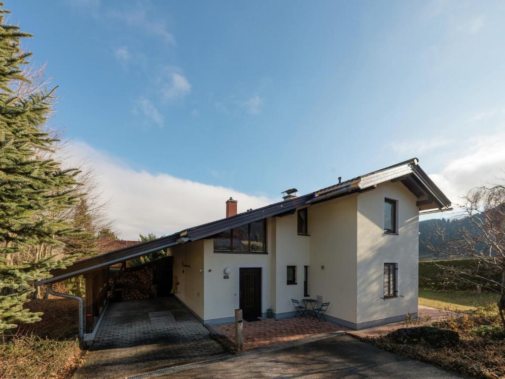 a detached house with a garage and a roof extension at Holiday Home in Groebming near Ski Slopes in Gröbming