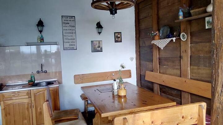 a kitchen with a wooden table and a wooden counter top at Granpa's House in Ruhovtsi