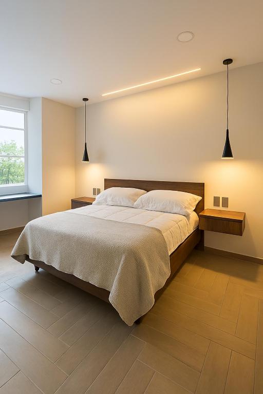 a bedroom with a large bed and two lights at Atrio Polanco in Mexico City