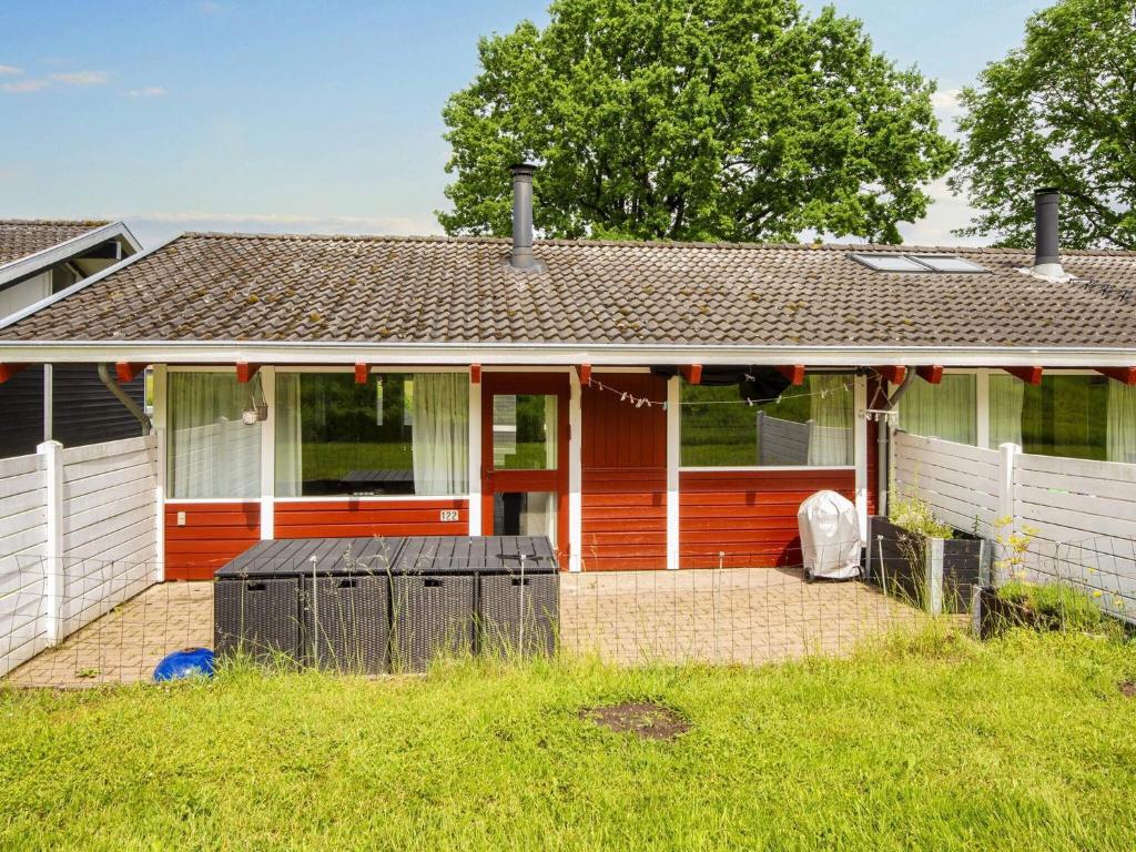 a home with a red house with a fence at 5 person holiday home in Aabenraa-By Traum in Aabenraa
