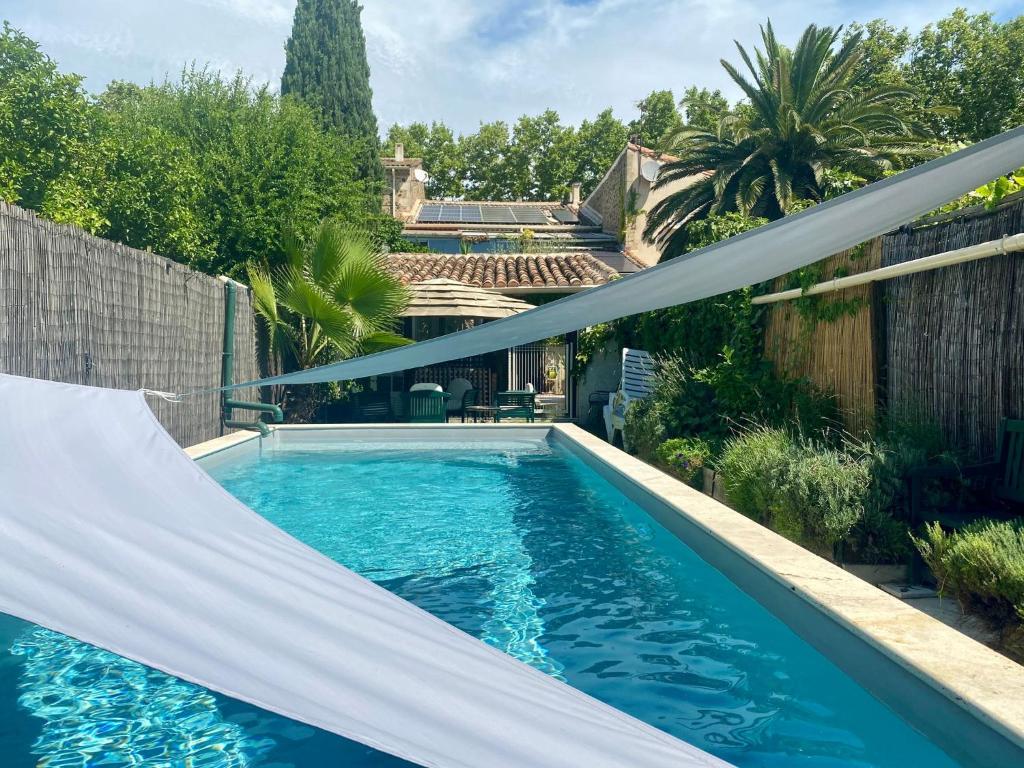 a swimming pool with a hammock in a backyard at Large Family Home in Mediterranean France in Tourbes
