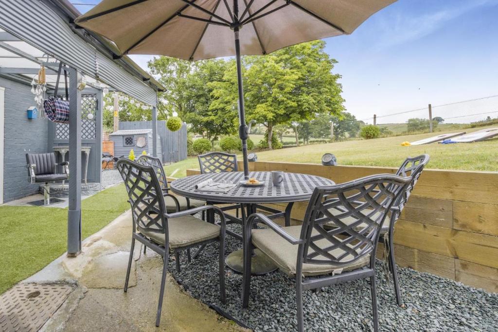 a table and chairs with an umbrella on a patio at 3 Bed in Forden oc-c30173 in Forden