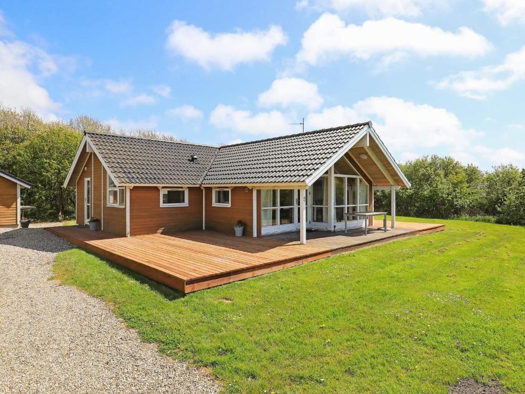 a house with a large deck in a yard at 6 person holiday home in Vestervig-By Traum in Vestervig