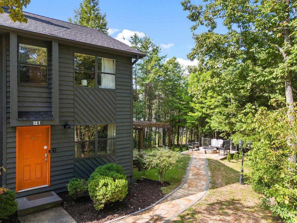 a house with an orange door and a yard at Ideal location Shared Pool & Near Dollywood in Pigeon Forge