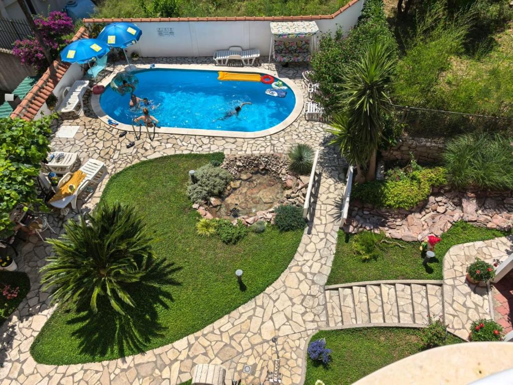 an overhead view of a swimming pool in a garden at Vila Koral in Petrovac na Moru