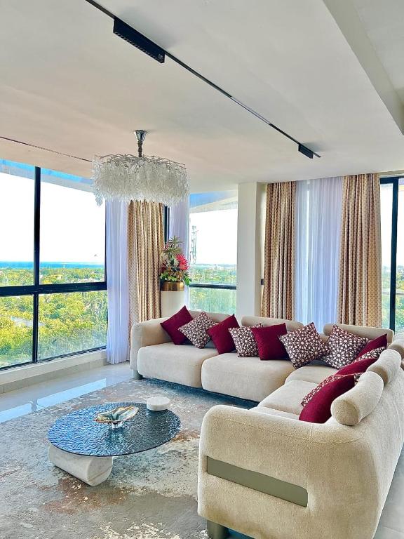 a living room with two couches and a table at Mira Heights Suites & Conferencing Mombasa in Mombasa
