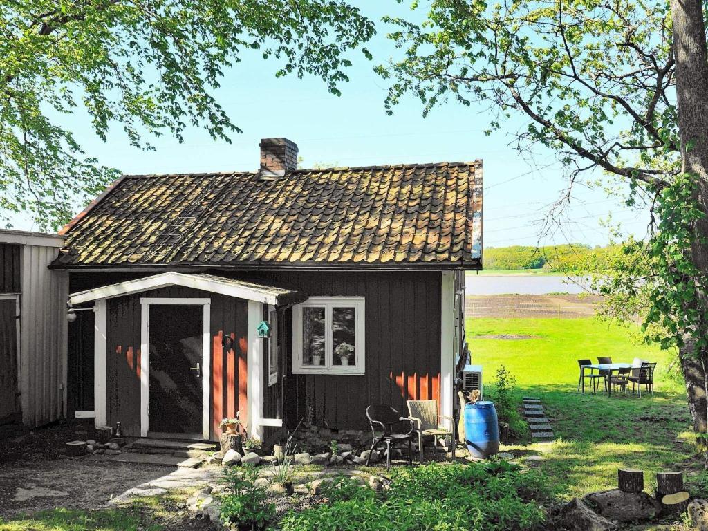 a small black house with a table and chairs at 4 star holiday home in kode in Kode
