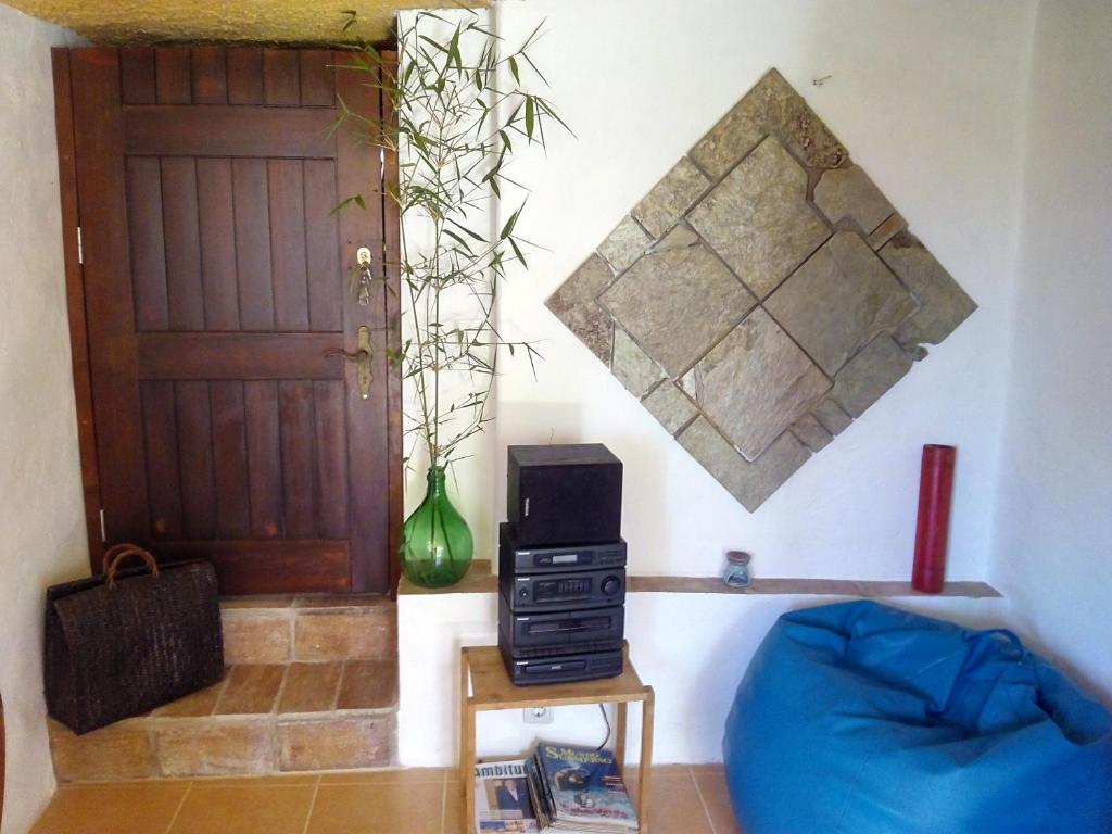 a living room with a blue couch and a door at Vivenda Familia Pedro in Vila do Bispo