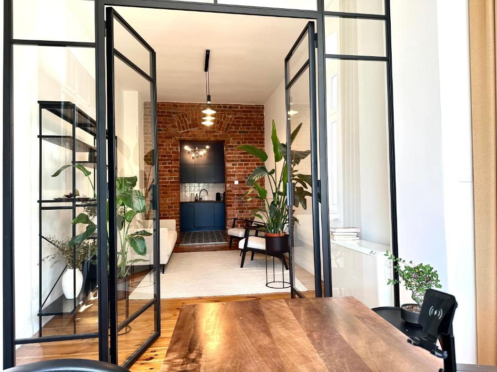a room with a table and some plants at Jagiellończyka Apartment - Self Check-In 20h in Wrocław