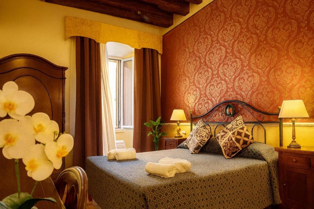 Un pat sau paturi într-o cameră la Hotel GIUBILEO