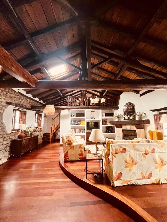a living room with two couches and a table at HdeC Hosteria de Castañeda Alojamiento Turistico in Puente Viesgo