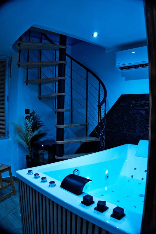 a bath tub in a room with blue lighting at CocooningRoom - Tain L'hermitage in Tain-lʼHermitage