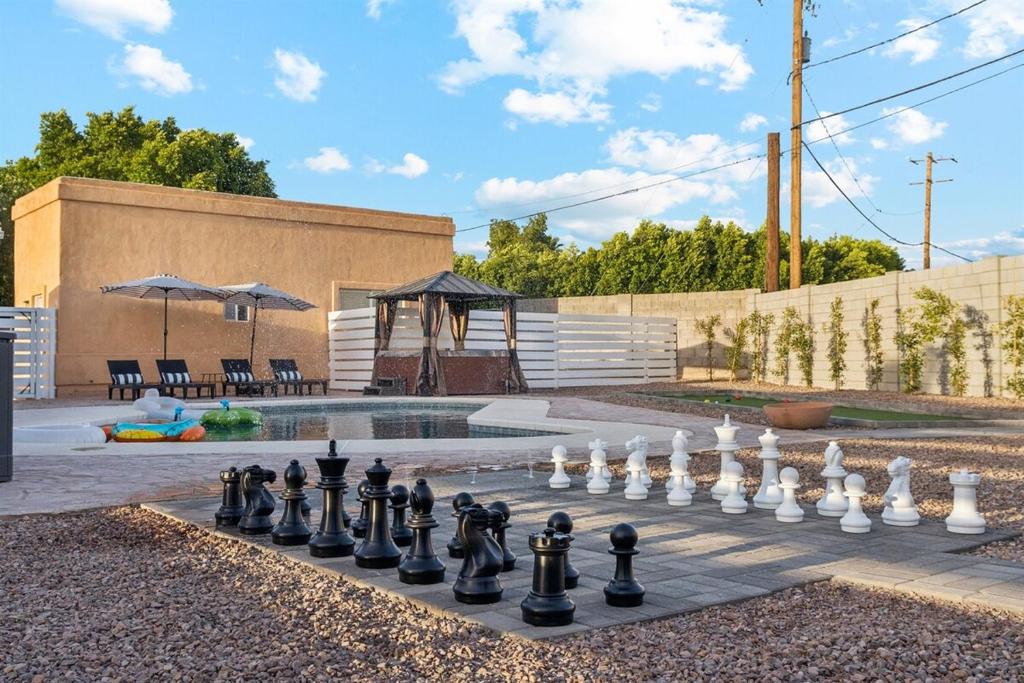 a chessboard is sitting on top of a patio at Bray House - Epic Shared Backyard - Pool - Games in Phoenix