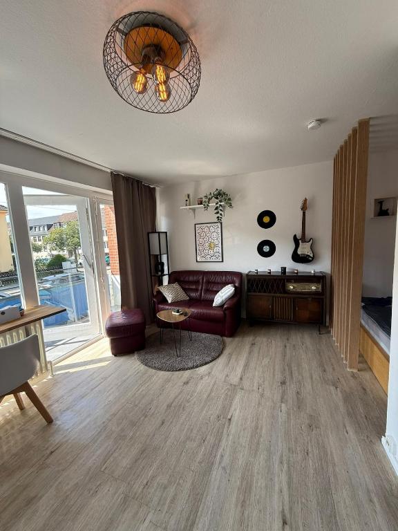 a living room with a couch and a table at Apartment Cozy Note für 2 in Bremerhaven