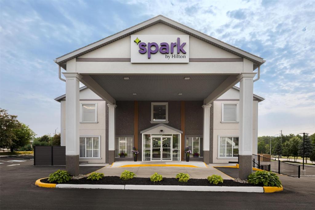 aospark building with a sign on top of it at Spark By Hilton Woodstock in Woodstock