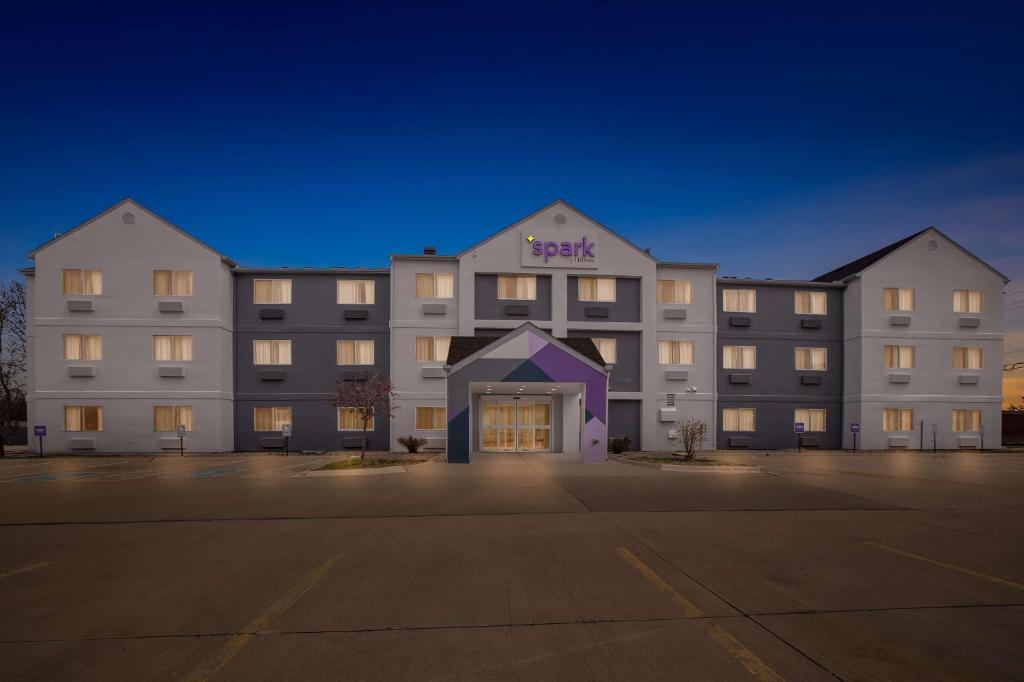 a large white building with a beast sign on it at Spark By Hilton Moline Quad Cities in Moline