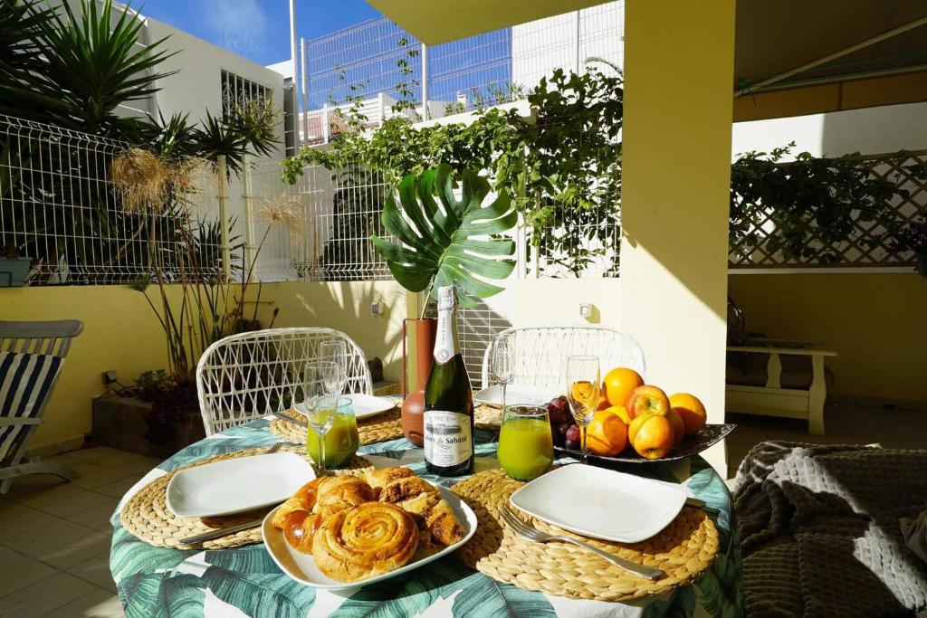 a table with plates and bowls of food on it at Apartment La Perla, Los Cristianos in Los Cristianos