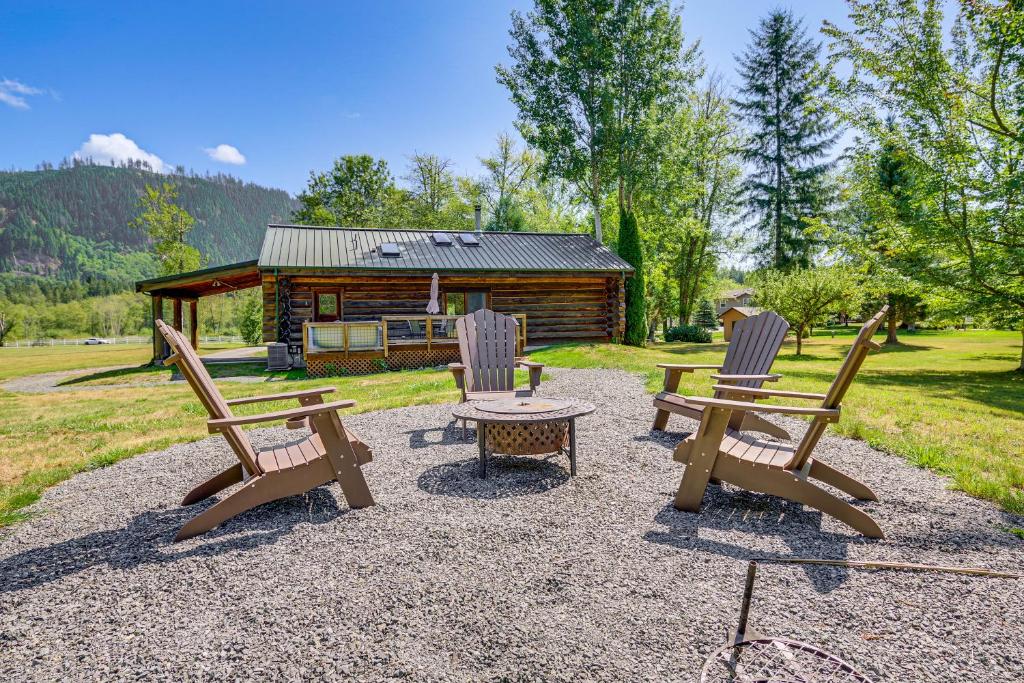 a group of chairs and a table in front of a cabin at Private Deck Dog-Friendly Arlington Cabin in Arlington